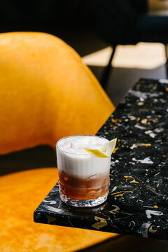 Whiskey Sour cocktail with egg white foam on ice