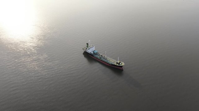 Aerial view of oil tanker ship navigating calm ocean water