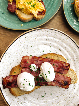 Breakfast toast with bacon and poached eggs
