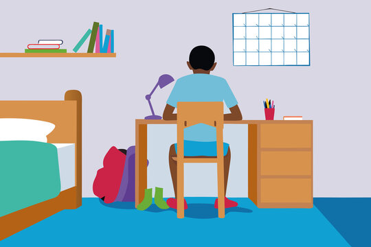 Young boy working from home at desk in simple room