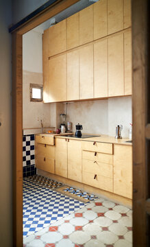 Work from home setup in a cozy kitchen with wooden cabinets