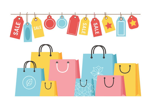 Colorful shopping bags and hanging sale tags on a white background