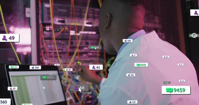 Male network tech viewing laptop spreadsheet at rack, alerts causing badge surge while fixing links