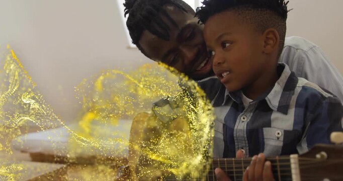 Father guiding son's left hand, strumming guitar, sparking singing in music with gold swirl overlay