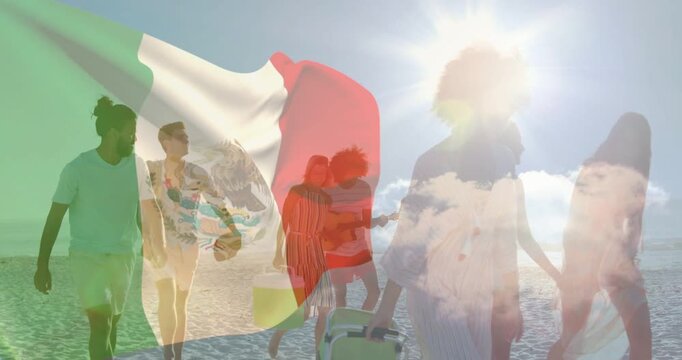 Travel group of eight walking on sunny beach, camera tracking, Mexican flag drifting, playing uke