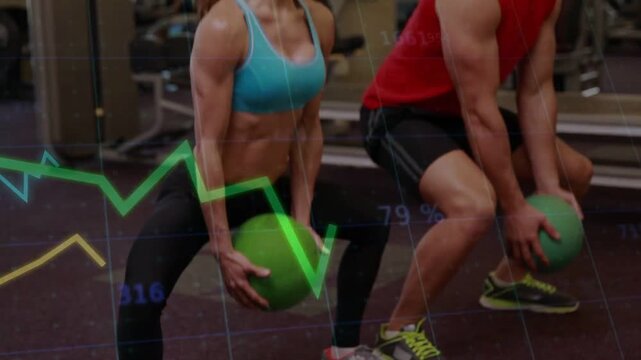 Camera rising, duo holding green med balls doing sync squats with line graphs tracking fitness data