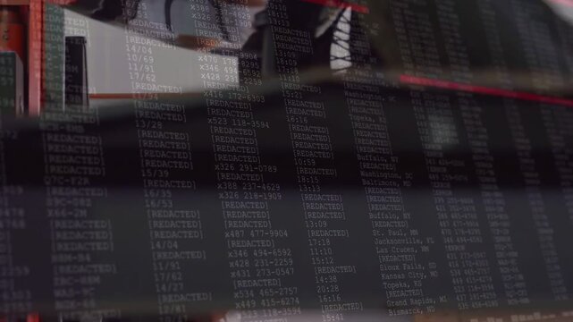 Vertical video: Tech wrenching wheel on lift, camera sliding revealing code overlay over hands