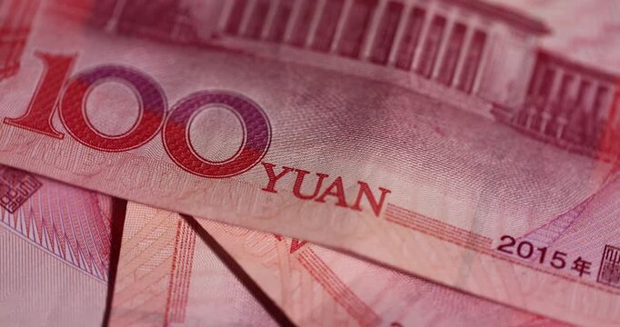 Chinese money with a face value of 100 yuan, Chinese cash in red with national symbols of China, closeup