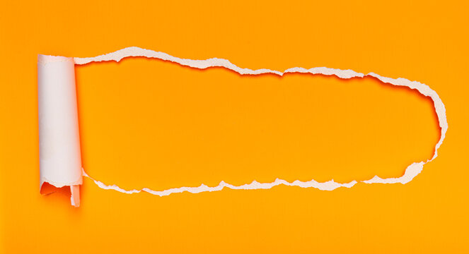 An orange paper ripped to reveal a space for text, with a rolled edge.