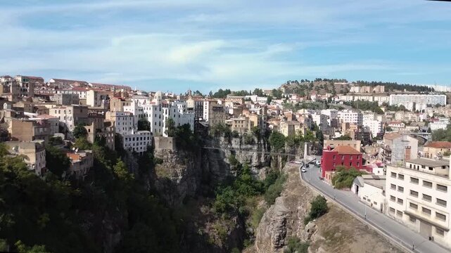 Panoramic aerial view of the historic cliffside city of Constantine, Algeria, featuring traditional architecture perched over the Rhumel River gorge.