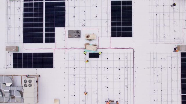 Top down aerial shot of rooftop solar installation from low to high altitude