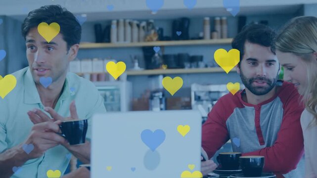 Animation of heart icons over diverse business people talking
