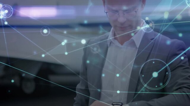 Animation of network of connections over caucasian businessman at airport
