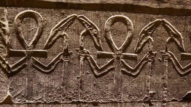 Hieroglyphs and images of Egyptian gods at the Ancient Egyptian Temple of Edfu. Edfu is the site of a Ptolemaic-era Temple of Horus and an ancient settlement in Egypt.