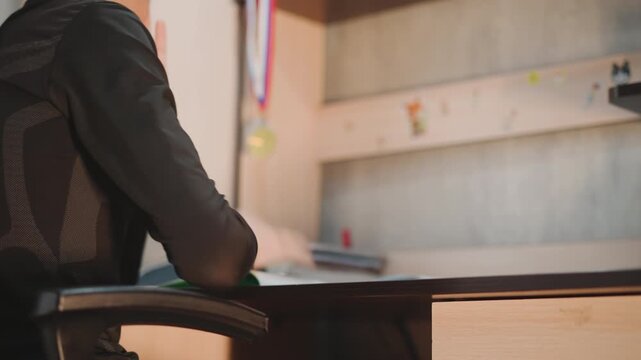 Silent youthful contemplation. Youthful person engages in thoughtful selfreflection at their workspace. Child in early years quietly contemplating and reflecting deeply at designated area