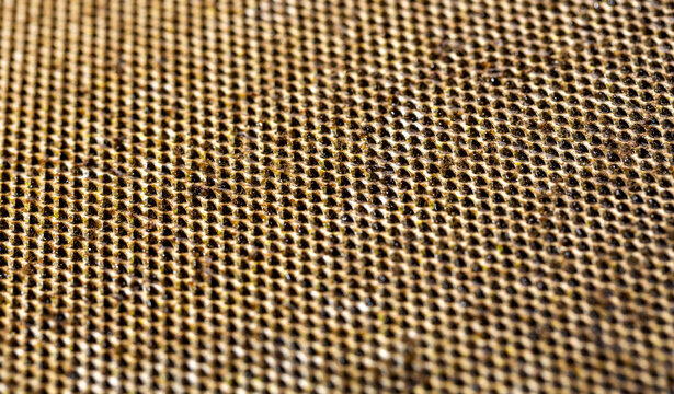 A close-up of Selective of a dirty kitchen range hood filter clogged with grease and soot