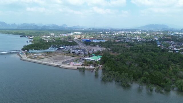 Aerial view of the HTMS Lanta warship museum featuring a decommissioned naval ship and aircraft display near Klong Jilad Ferry Pier in Krabi Thailand coastal area.
Surrounded by stunning nature.