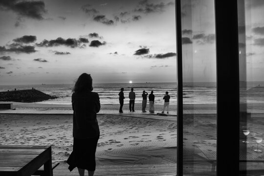 Costa Nova, Aveiro, Portugal - March 27, 2026 : People watching the sunset. beautiful sunset on Costa Nova Beach, Aveiro, Portugal