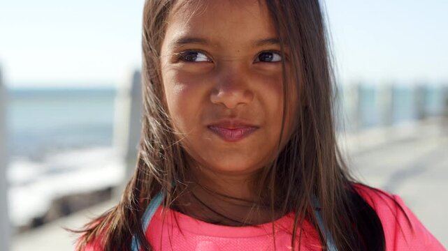 Face, beach and girl at promenade, kid and summer holiday to relax, travel weekend and thinking. Outdoor, youth or child with break, choice or ocean for vacation, reflection or coastal trip in Brazil