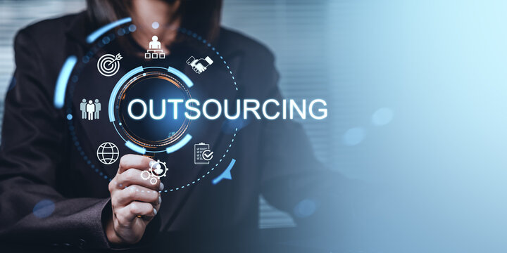 Business person touching digital outsourcing interface with futuristic icons illustrating corporate service delegation concept in modern workspace.