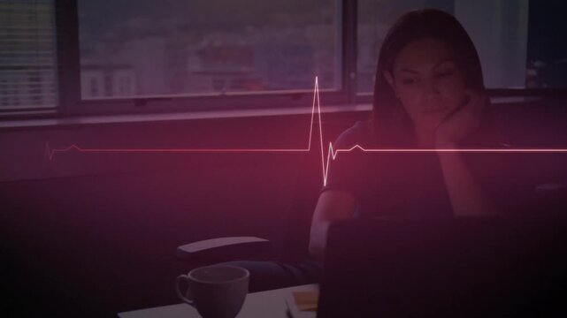 Animation of illuminated heart rhythm over thoughtful woman with coffee working on laptop