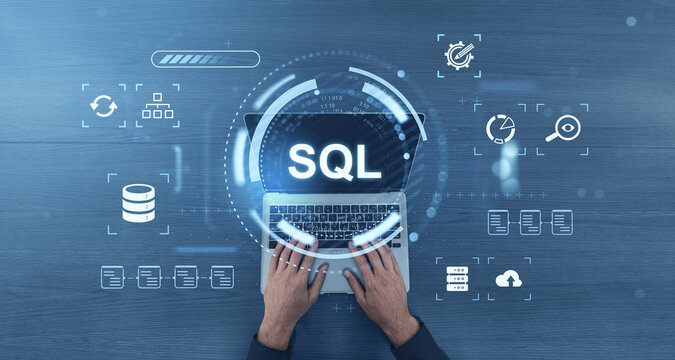 Hands typing on laptop with SQL text surrounded by digital database symbols on blue background showing data management concept in modern business technology sector.