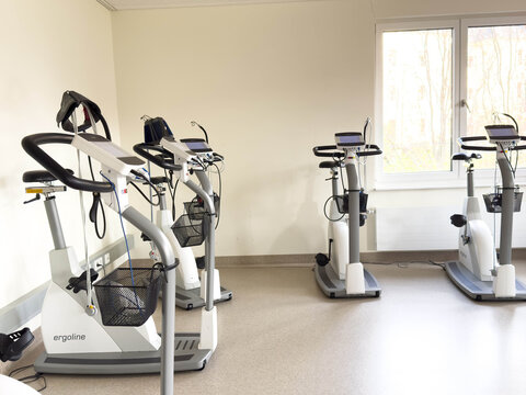 Klagenfurt, Austria - March 25, 2026: Rehabilitation center with ergoline exercise bikes arranged in a bright room featuring large windows and a clean, modern interior design