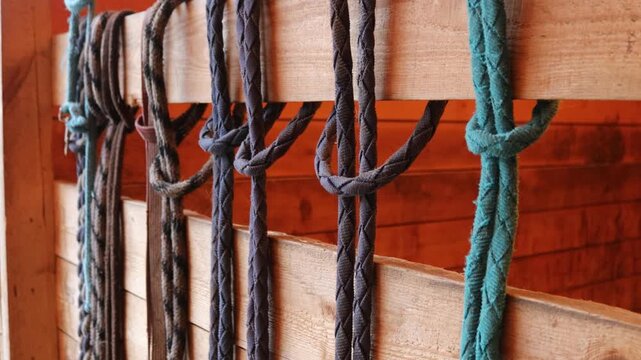 Close-up shot of ropes stacked on wooden wall, suitable for decorative or architectural purposes