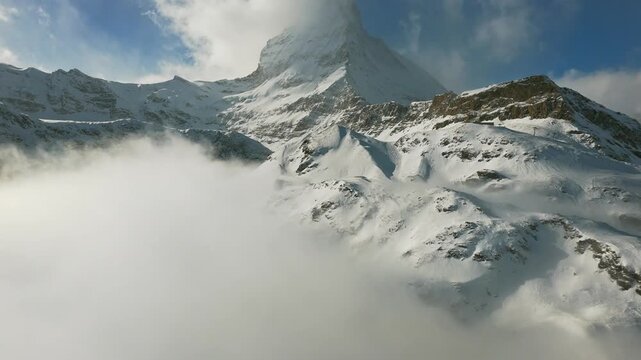 Pedestrians walking on Zermatt village main street in winter Switzerland