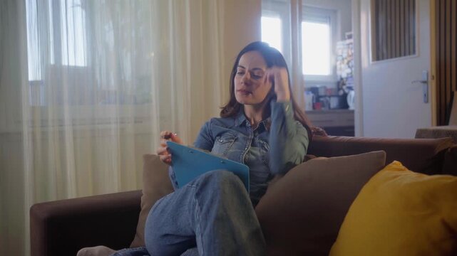 Window, writing and woman with notebook, thinking and planning for story with ideas and inspiration. Creative, author and young person with journal for novel, home or brainstorming with notes on seat