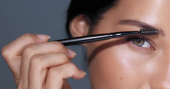 Woman Applying Eyebrow Gel with Mascara Brush Close-up Beauty