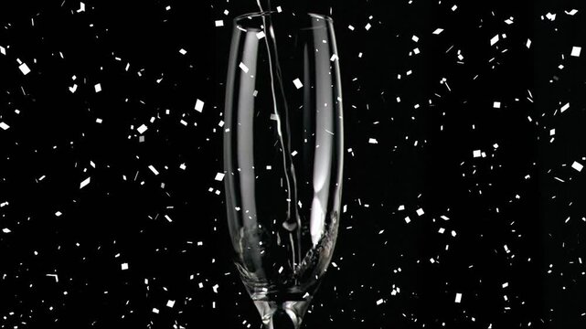 Animation of confetti over glass of champagne