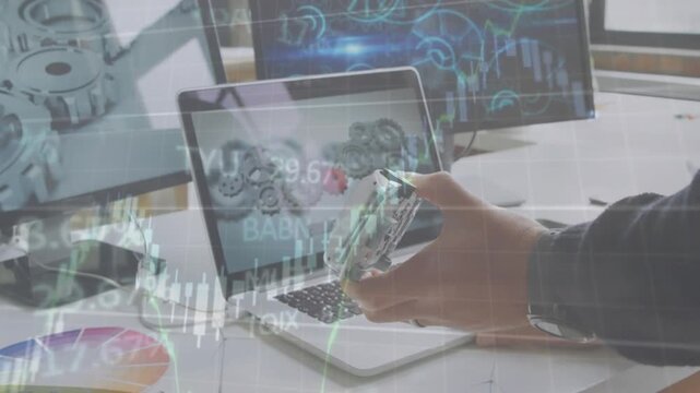 Animation of financial data processing over mid section of engineer holding a car model at office