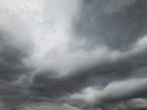 Dramatic dark storm clouds background, moody overcast sky, heavy grey rain clouds, atmosphere before the storm, nature weather photography