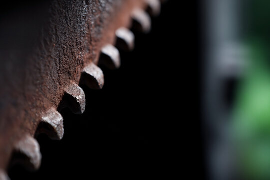 heavily rusted industrial gear wheel or saw blade teeth with gritty texture and sharp edges