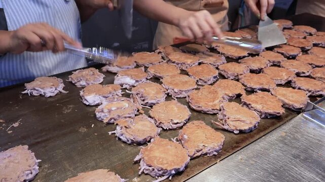 Almost done for serving, footage of delectable Kanom Babin Thai Coconut Dessert on Street Pan