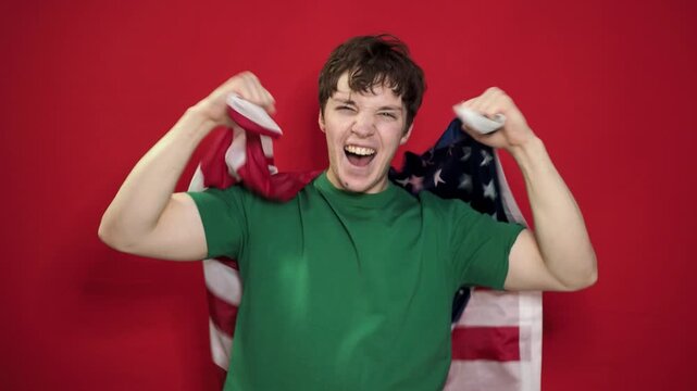 A football fan rejoices at his team's victory and shouts hurray.