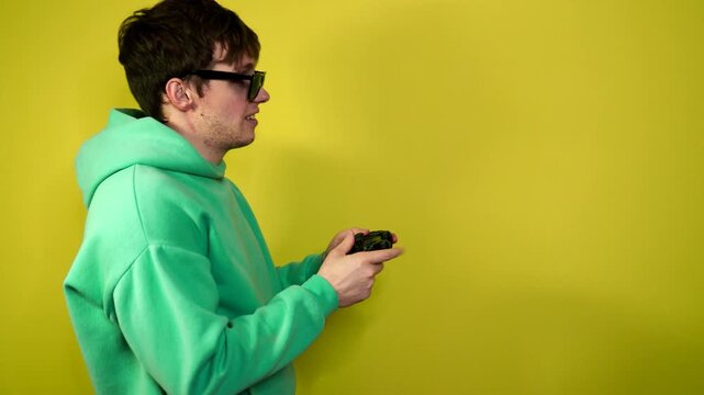 A man plays the console, video games react strongly and emotionally while sitting on the couch.