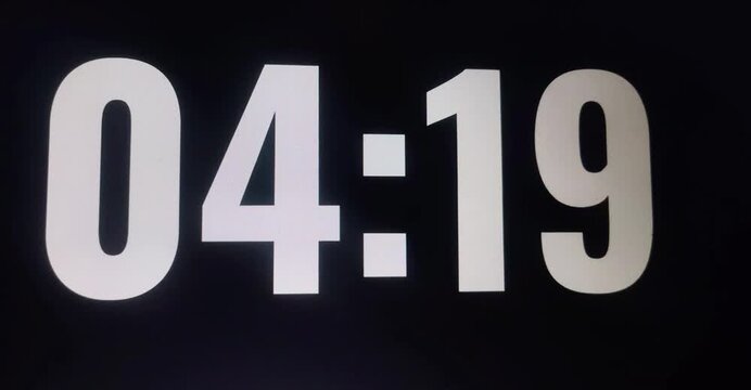 Time lapse of a digital flip clock. 5 minutes countdown in black background. 
