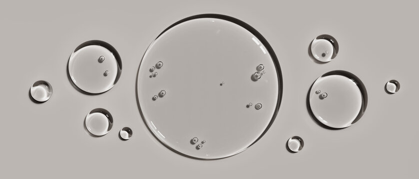Transparent cosmetic serum gel drops isolated on a light grey background illustrating hydration and skin care concepts for dermatology brand packaging design advertising layouts and visual templates