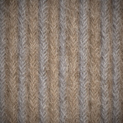 Fototapeta premium Close up of a textured surface showing alternating patterns of brown and gray fibers during daylight hours