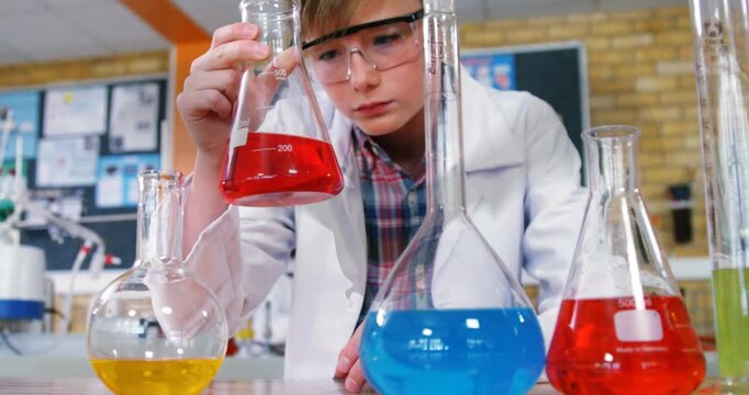 Animation of bat icon over caucasian schoolboy at science class