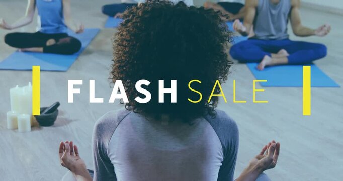 Yoga teacher sitting, yellow block popping back starting FLASH SALE showing over blue mats for sale