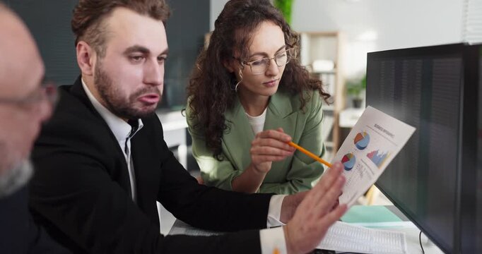 Accountants analysts team review finance report charts. Colleagues discuss data at computer screens in office, planning budgets and tax compliance. Clear concept of office finance teamwork.