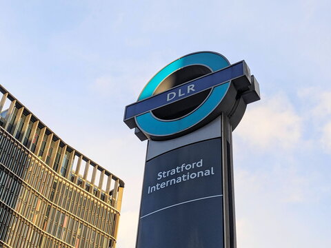 Striking DLR Stratford International Station Signage against a Modern Urban Background