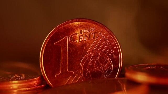 Close-up of a 1 Euro Cent coin with changing colored lights