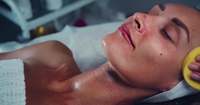 Woman Receiving Facial Treatment at Spa Clinic