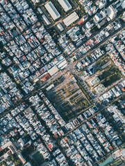 Fototapeta premium Aerial top view of dense urban neighbourhood with grid streets and residential buildings, Drone perspective of city infrastructure and architecture pattern in Asian Danang city, Da Nang, Vietnam