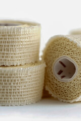 Obraz premium Two rolls of medical bandages stacked on top of each other, ready for use