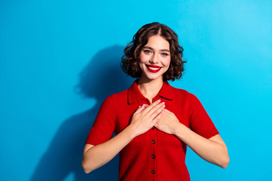 Young chic gorgeous woman smiling in red sweater against blue background